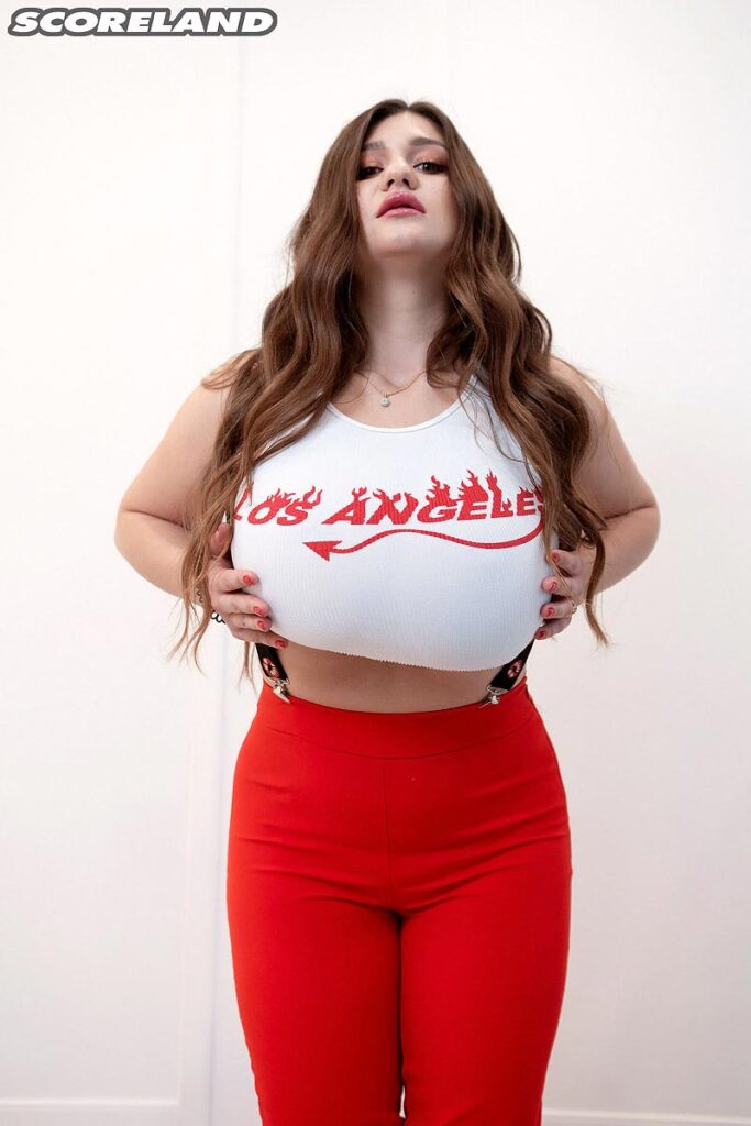 Demmy Blaze Stretching a white top and suspenders